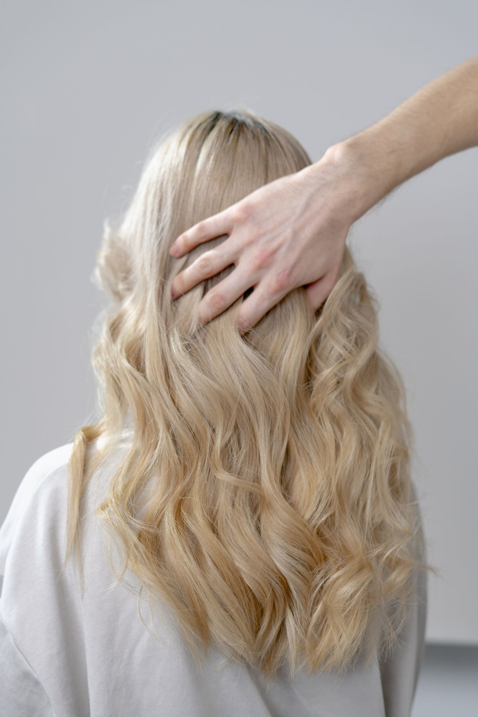 Applying a curl enhancing styling product by scrunching wavy hair