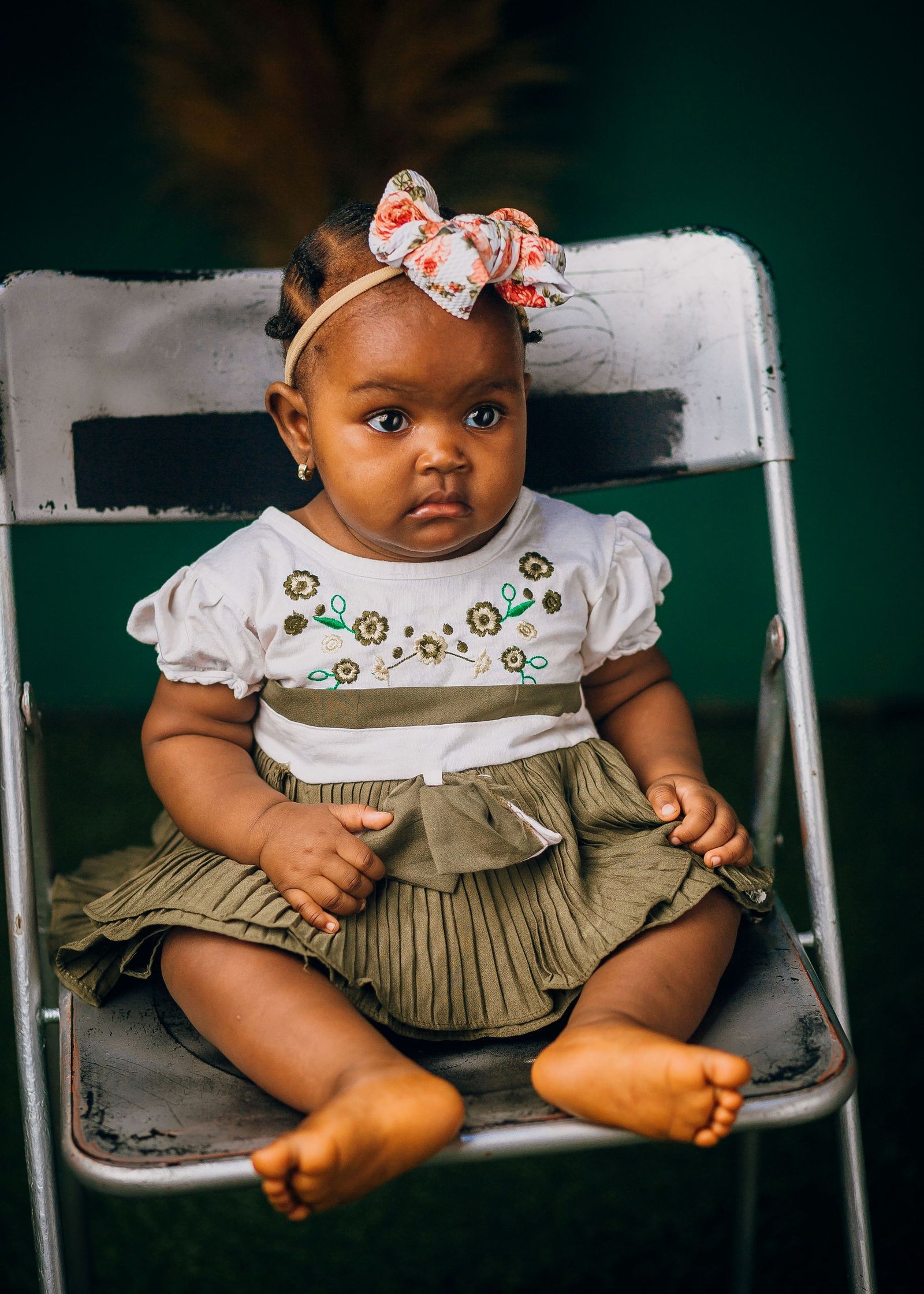 Baby girl wearing a soft fabric headband with a bow, an example of a gentle infant hairstyle