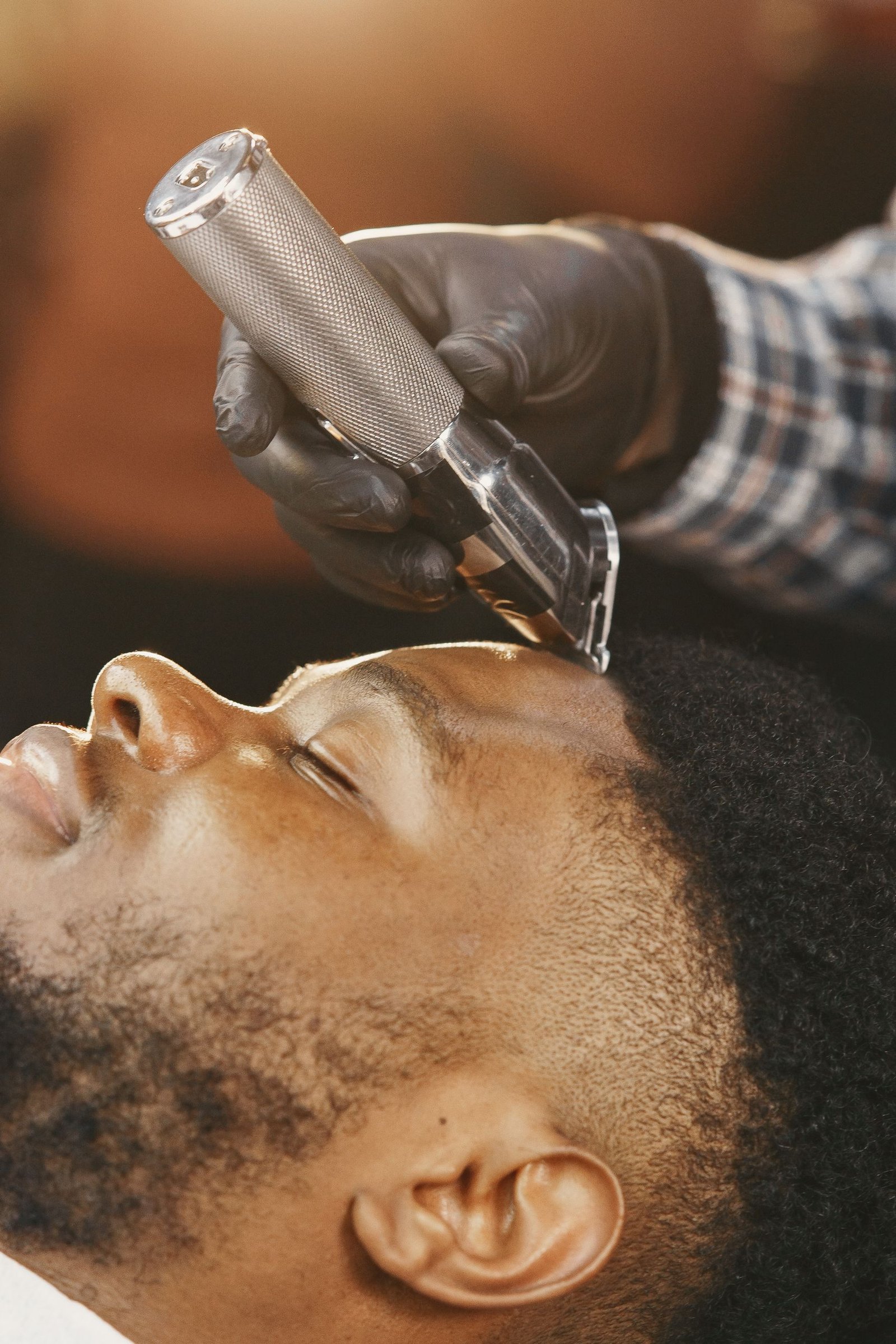 Close-up of a taper fade haircut with a sharp line up along the hairline