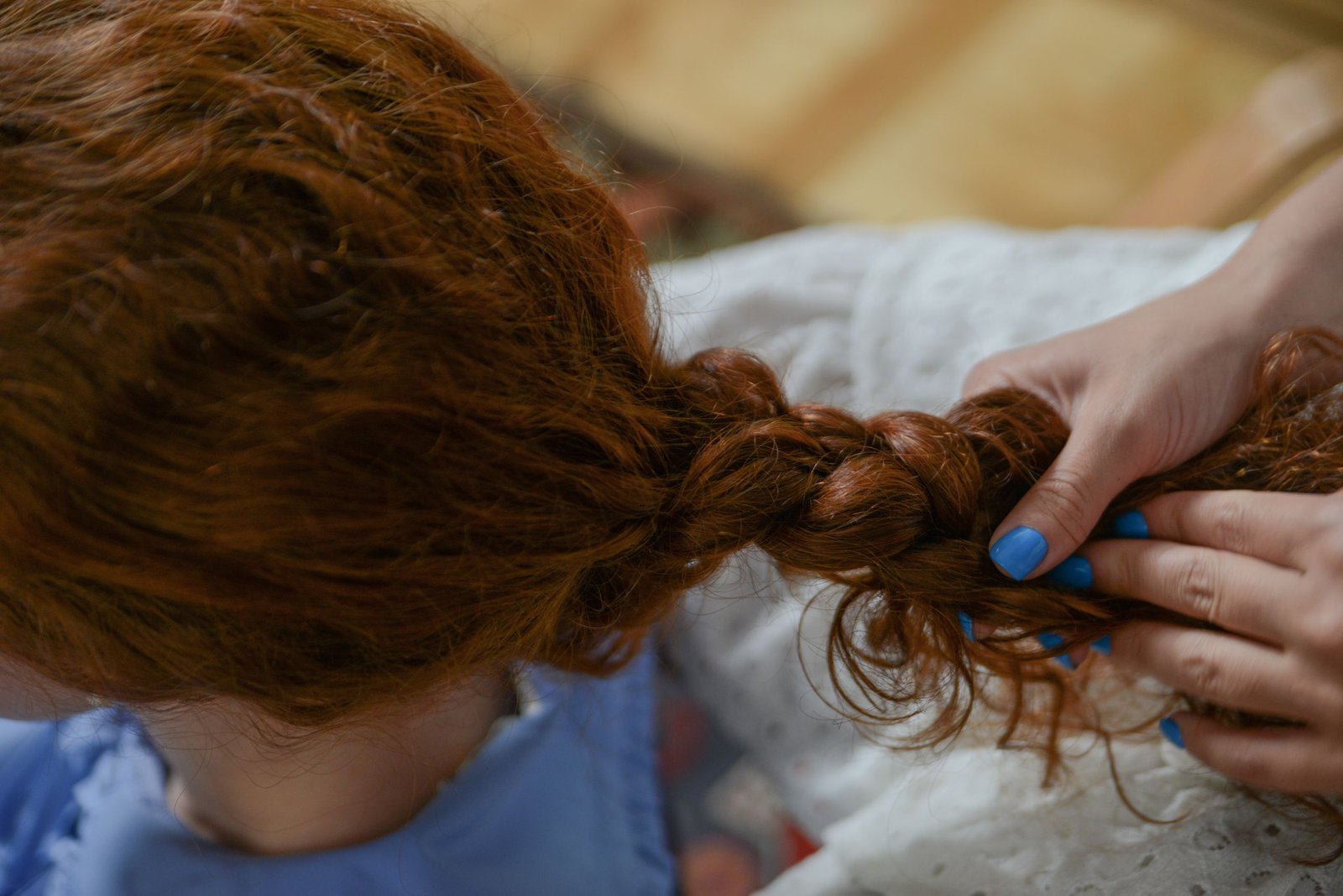 Close-up of hands installing individual box braid sections
