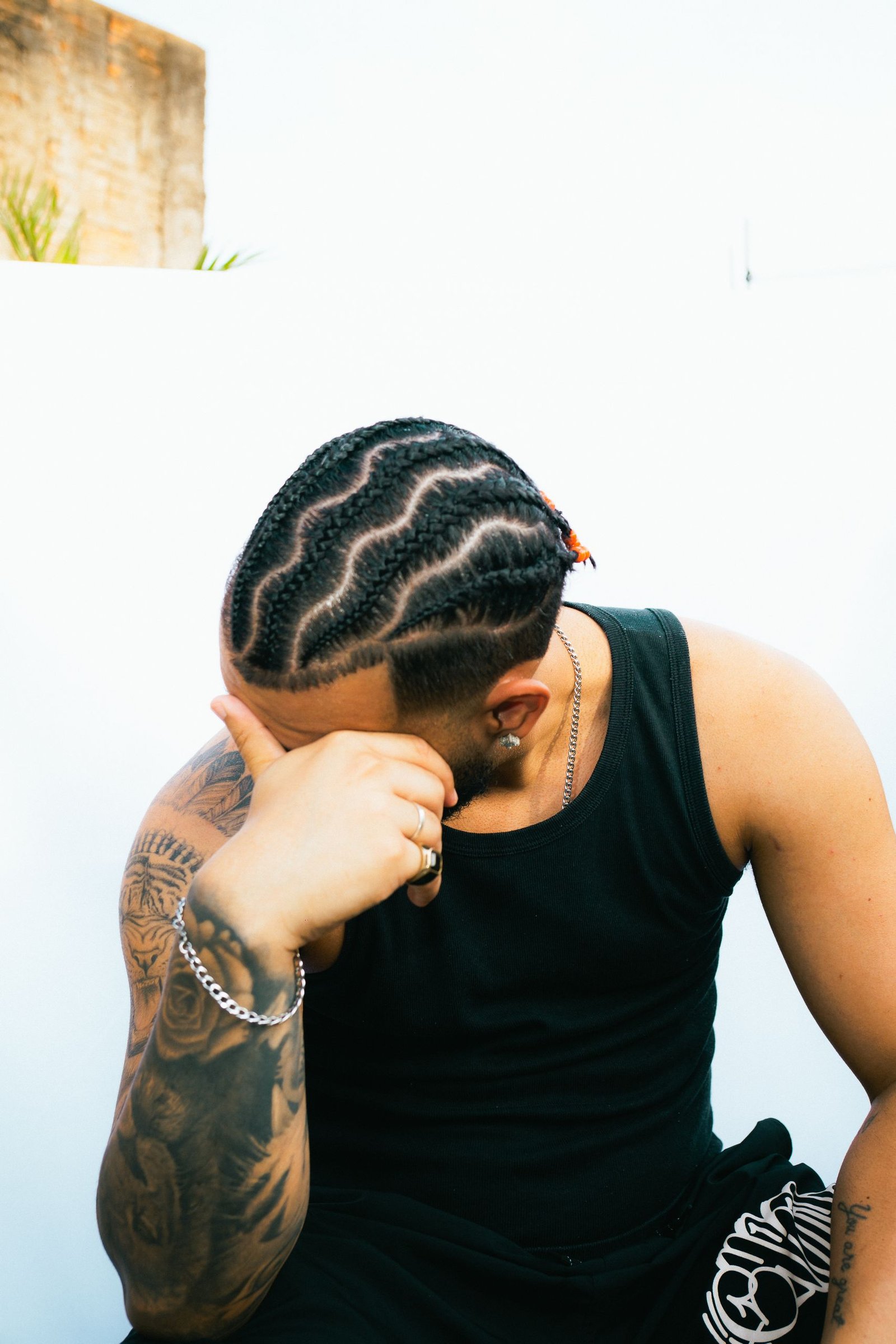 Close-up of intricate braided hairstyle patterns on a man