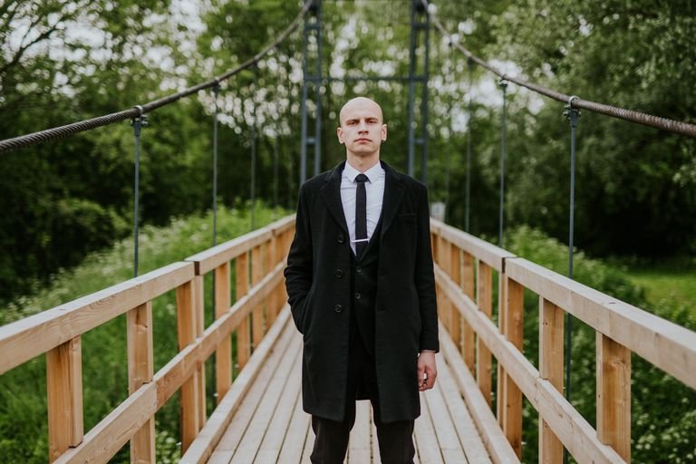 Confident bald man in a suit outdoors