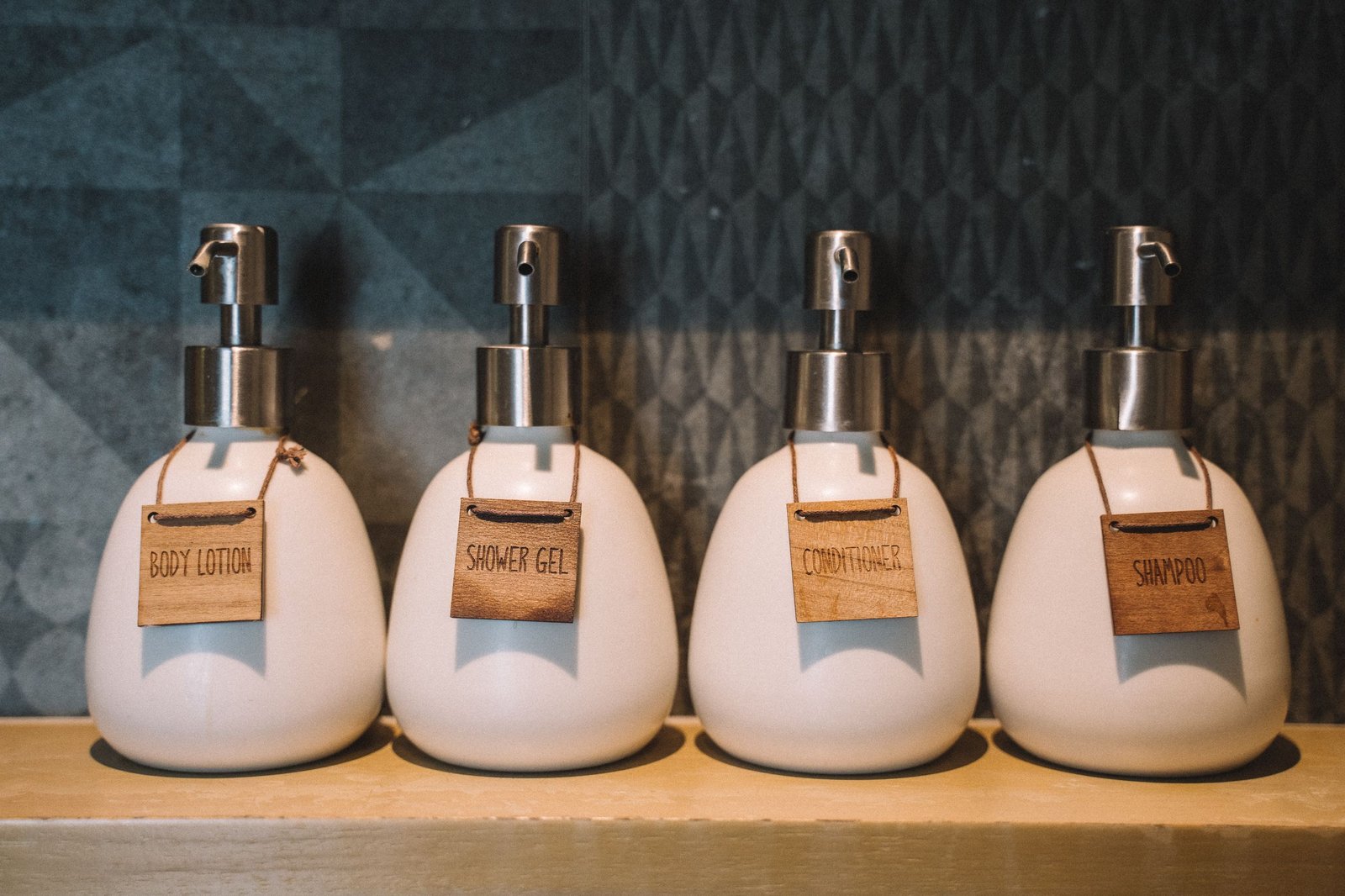 Curl-activating shampoo bottles lined up on a bathroom shelf