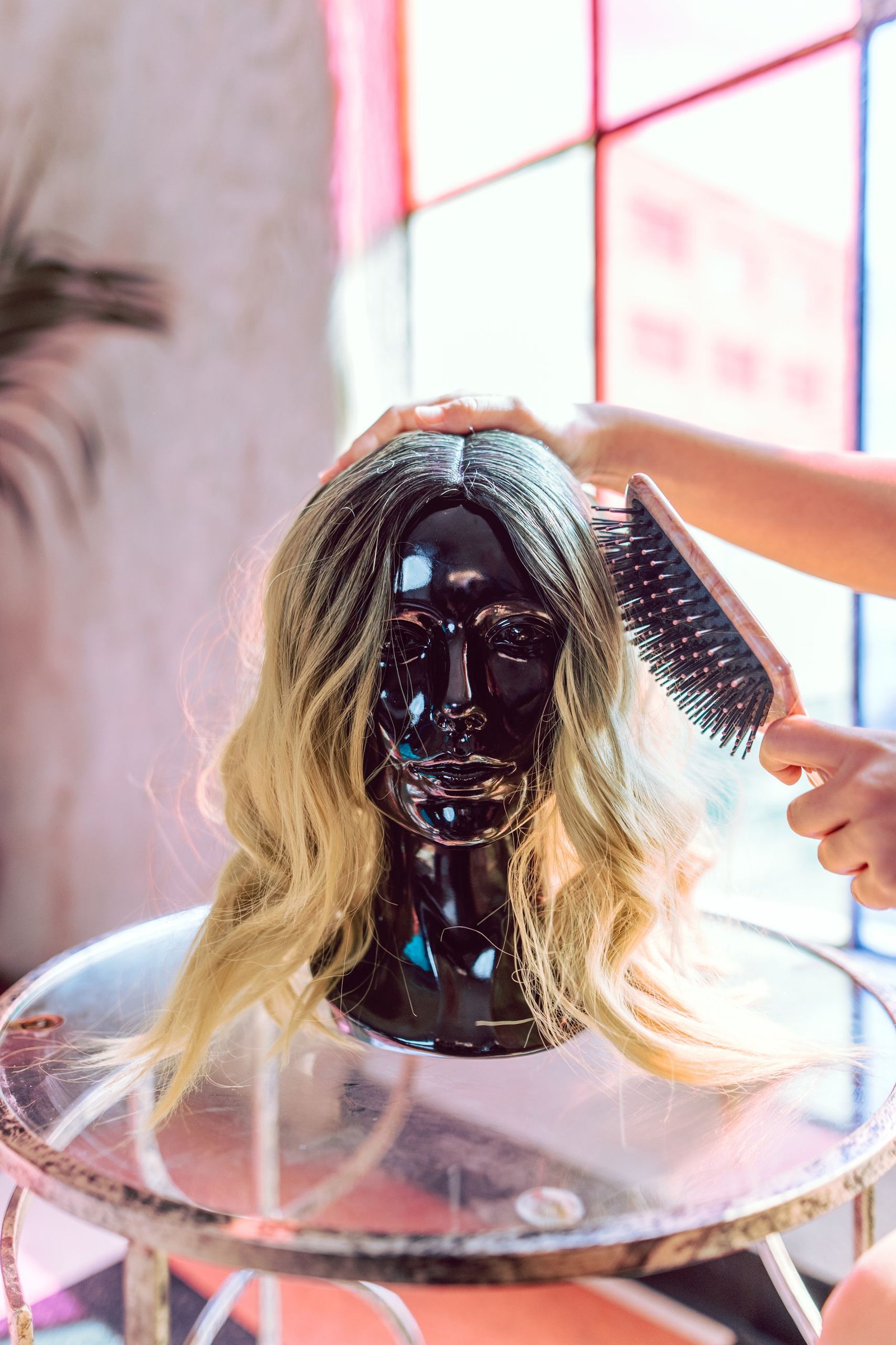 Human hair wig styled on a mannequin head showing natural texture and fit