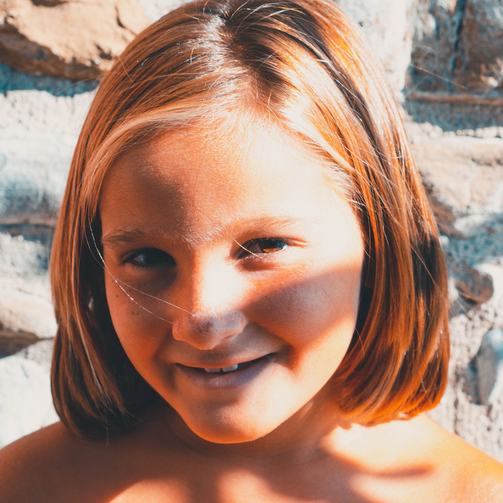 Little girl with a chin-length bob haircut smiling