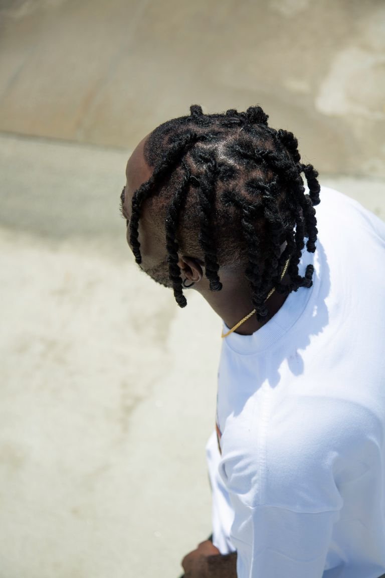 Man wearing shoulder length box braids outdoors