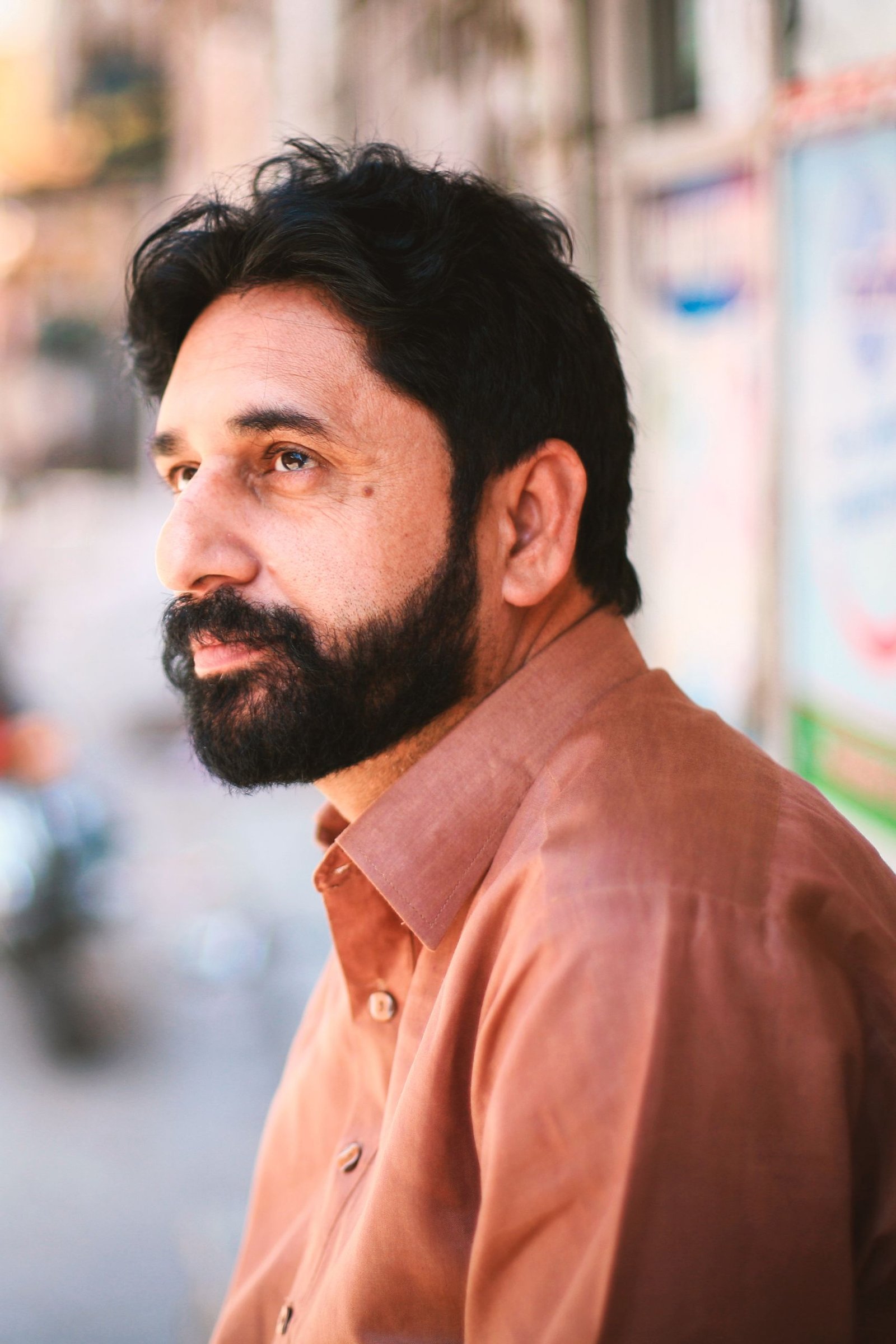 Man with a short, well-groomed beard in profile