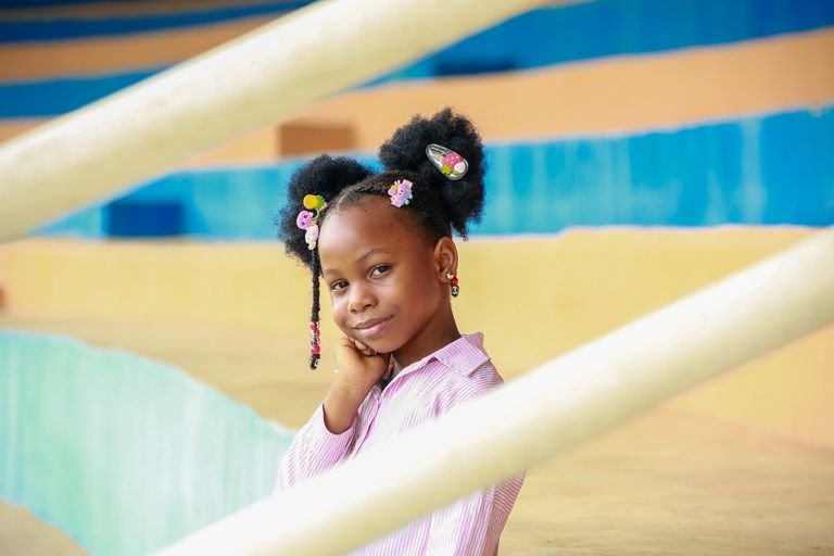 Smiling girl with colorful natural hairstyle accessories