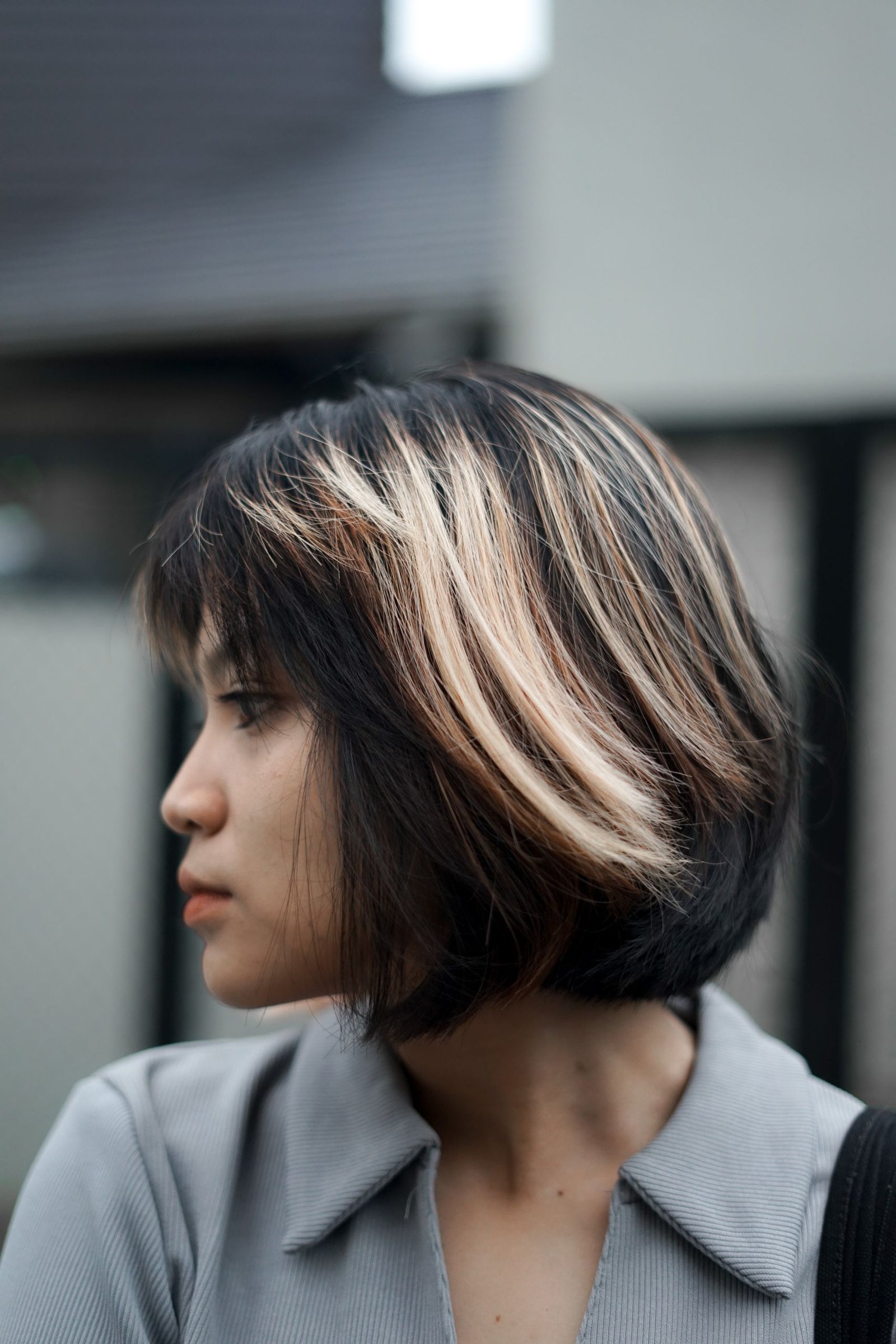 Woman with a short bob haircut featuring balayage highlights.