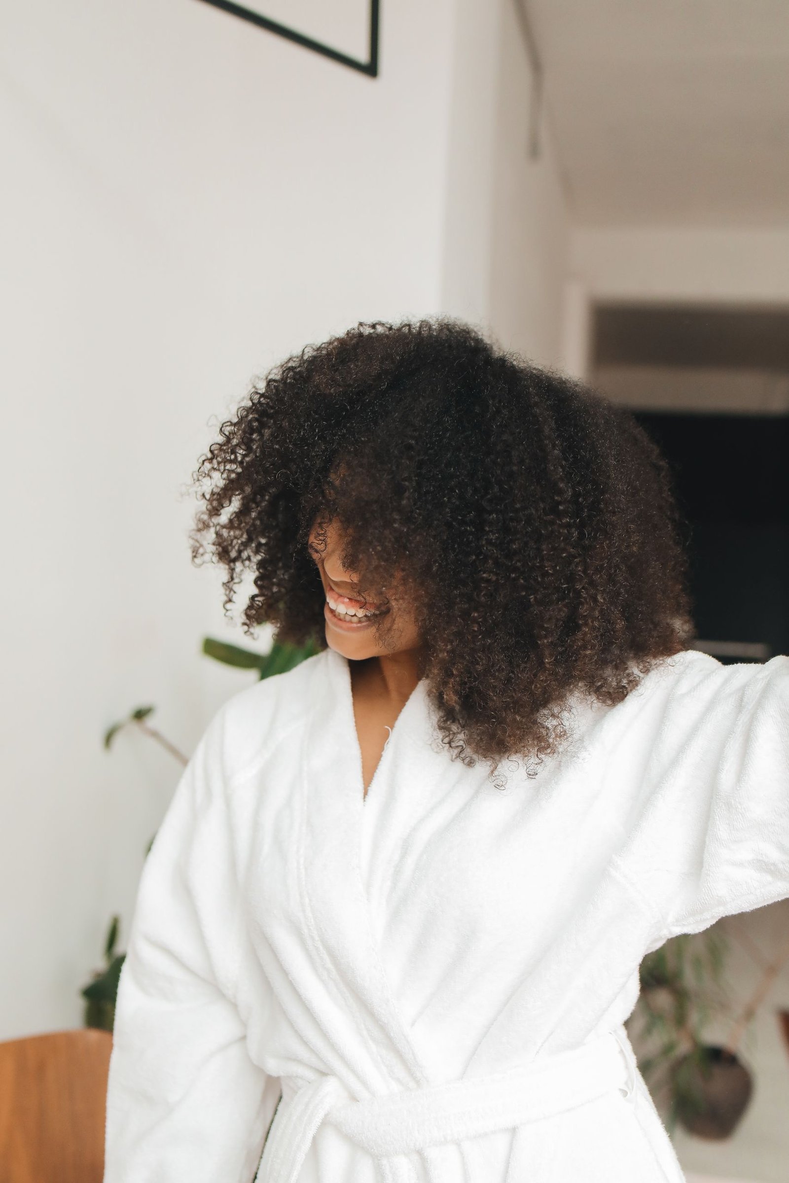 Woman with curly hair caring for her curls after washing
