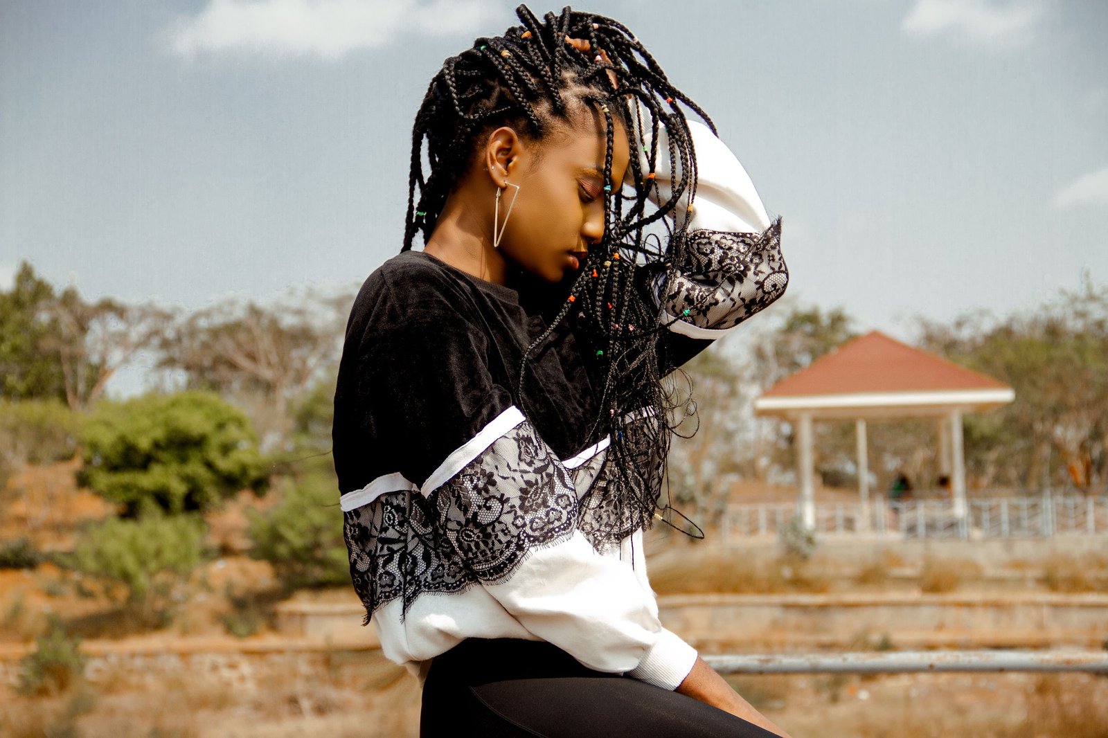 Woman with natural hair gently caring for her curls, a form of protective hair routine