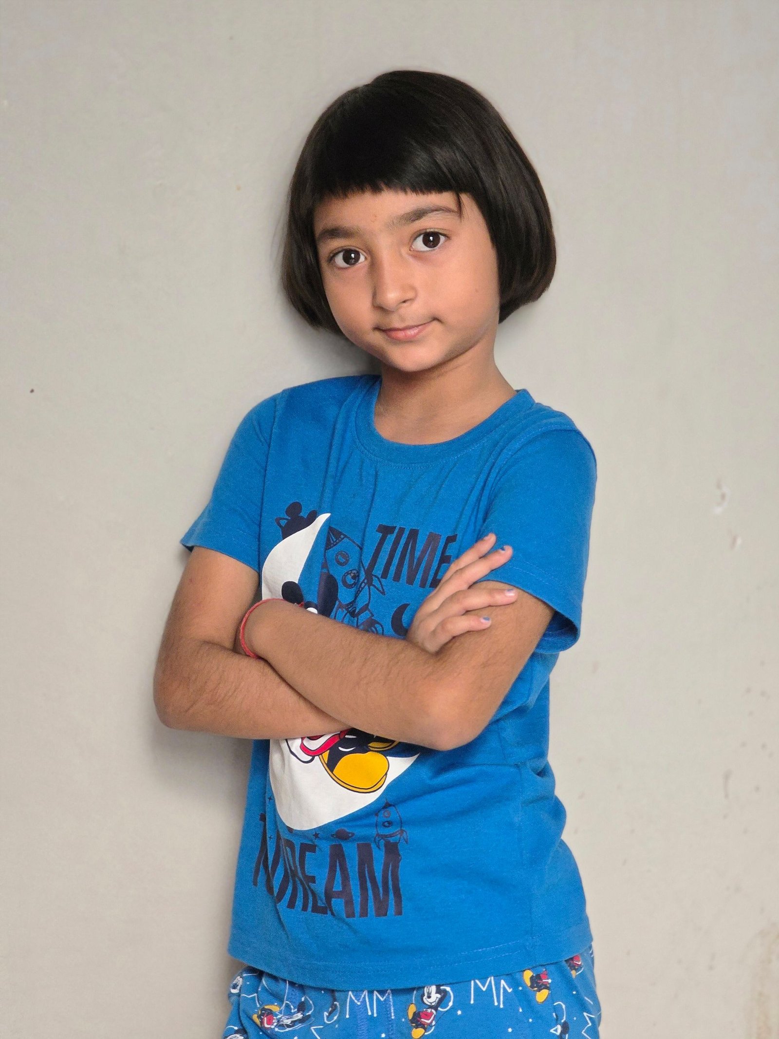 Young girl with a blunt bob haircut standing confidently