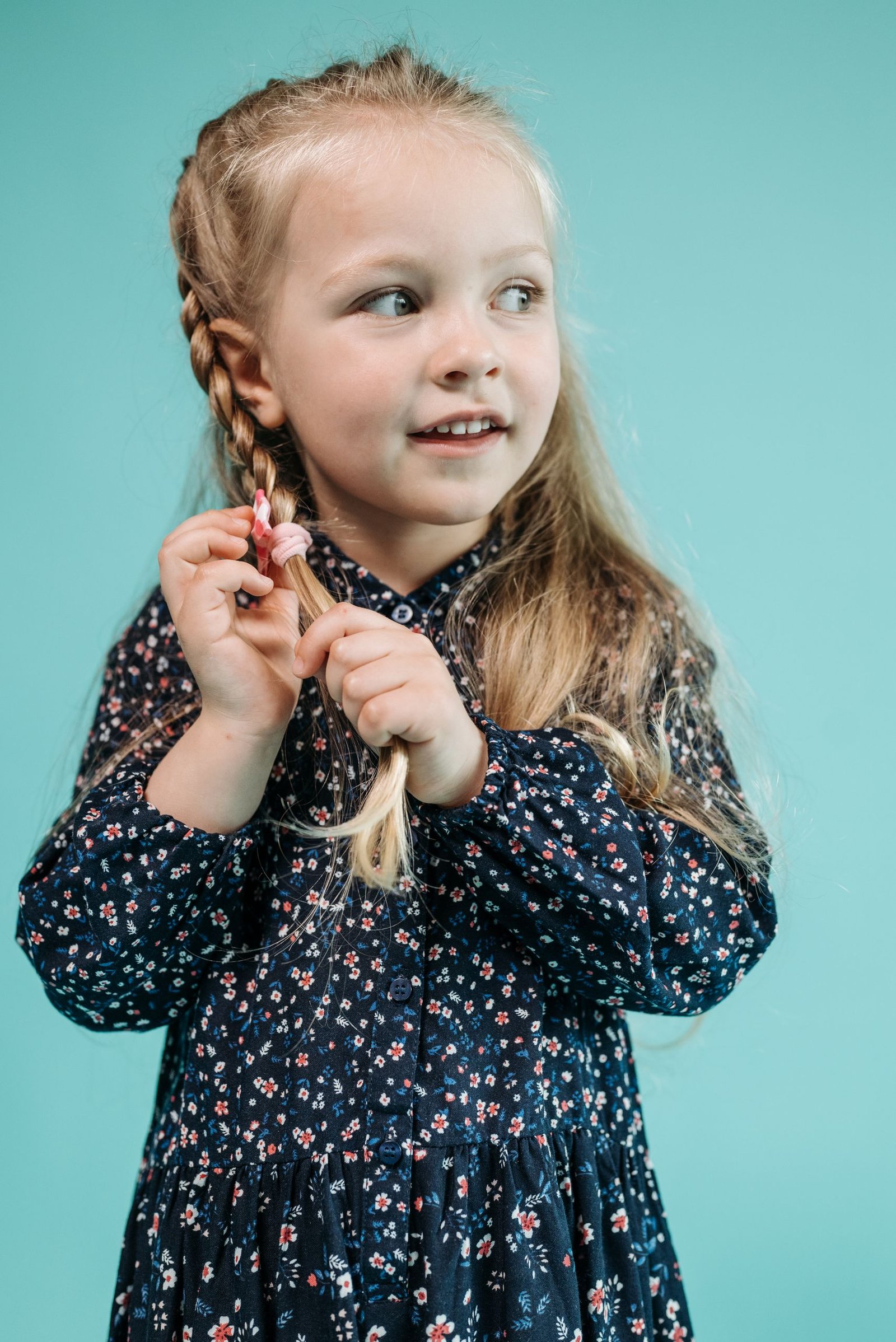 Young girl with a loose, simple braid, an example of a gentle hairstyle for longer toddler hair
