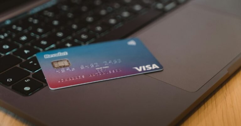 Debit card resting on a laptop keyboard representing a UAE PAYEZ payroll card