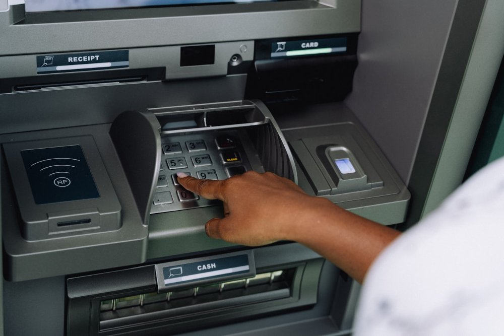 Person withdrawing cash from an ATM machine in the UAE