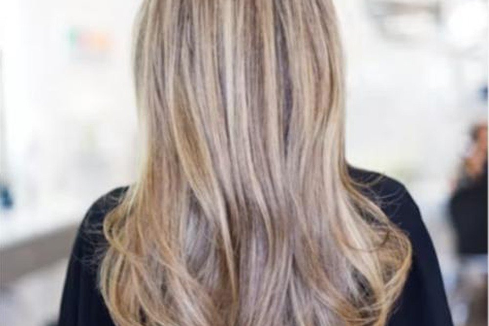 Cool-toned ash blonde hair with a smoky, neutralized undertone