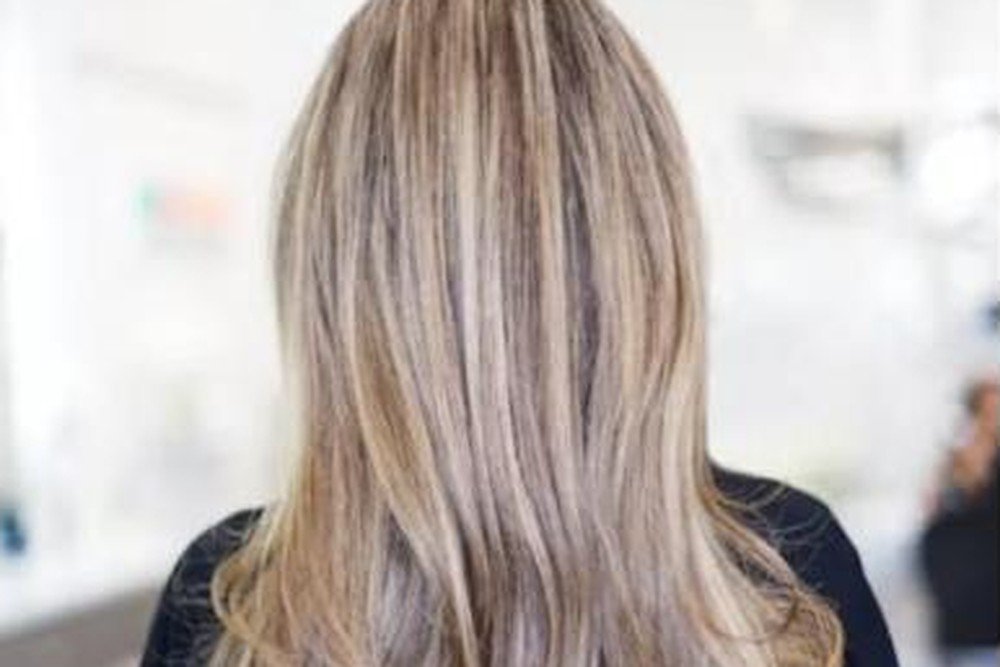 Close-up of brown balayage hair showing hand-painted caramel highlights blending into a brunette base