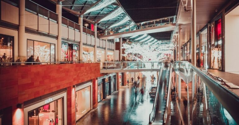 Shopping mall interior with escalators near a metro exit