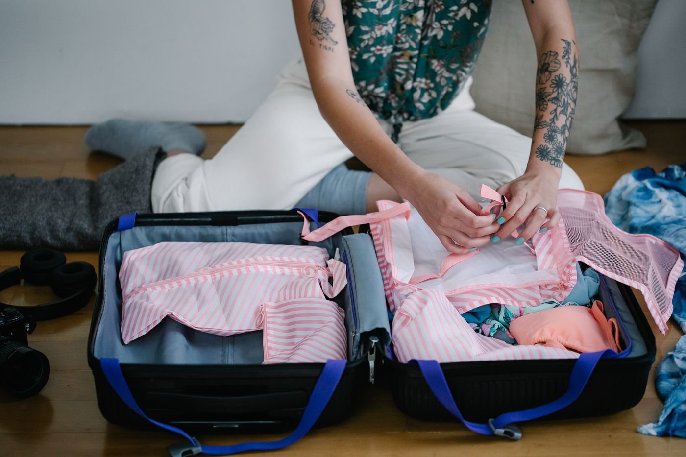 Woman packing her travel suitcase indoors