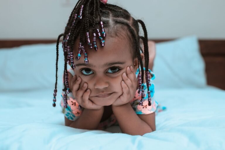 Child with braided hair and beads relaxing