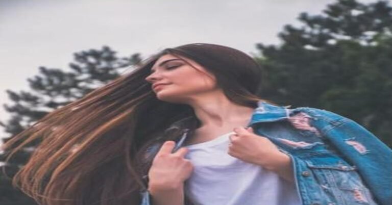 Woman with long healthy brown hair blowing in the wind outdoors