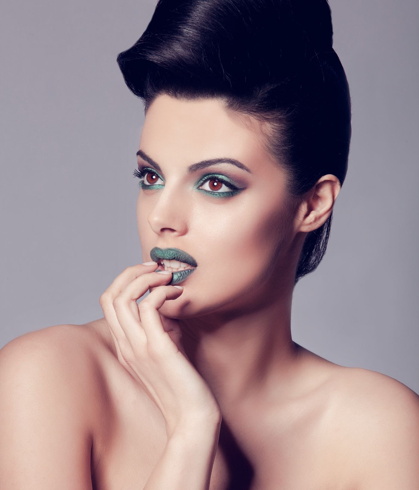 Model with an updo hairstyle and glamour makeup in a studio